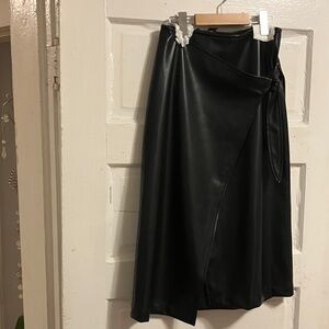 7 for Mankind.  Like new black faux leather n wrap style skirt. Sz M waist 27”